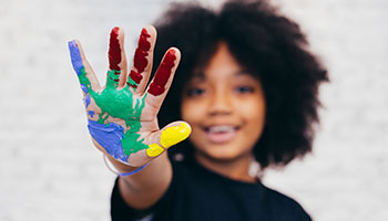 Image of a girl with a painted hand