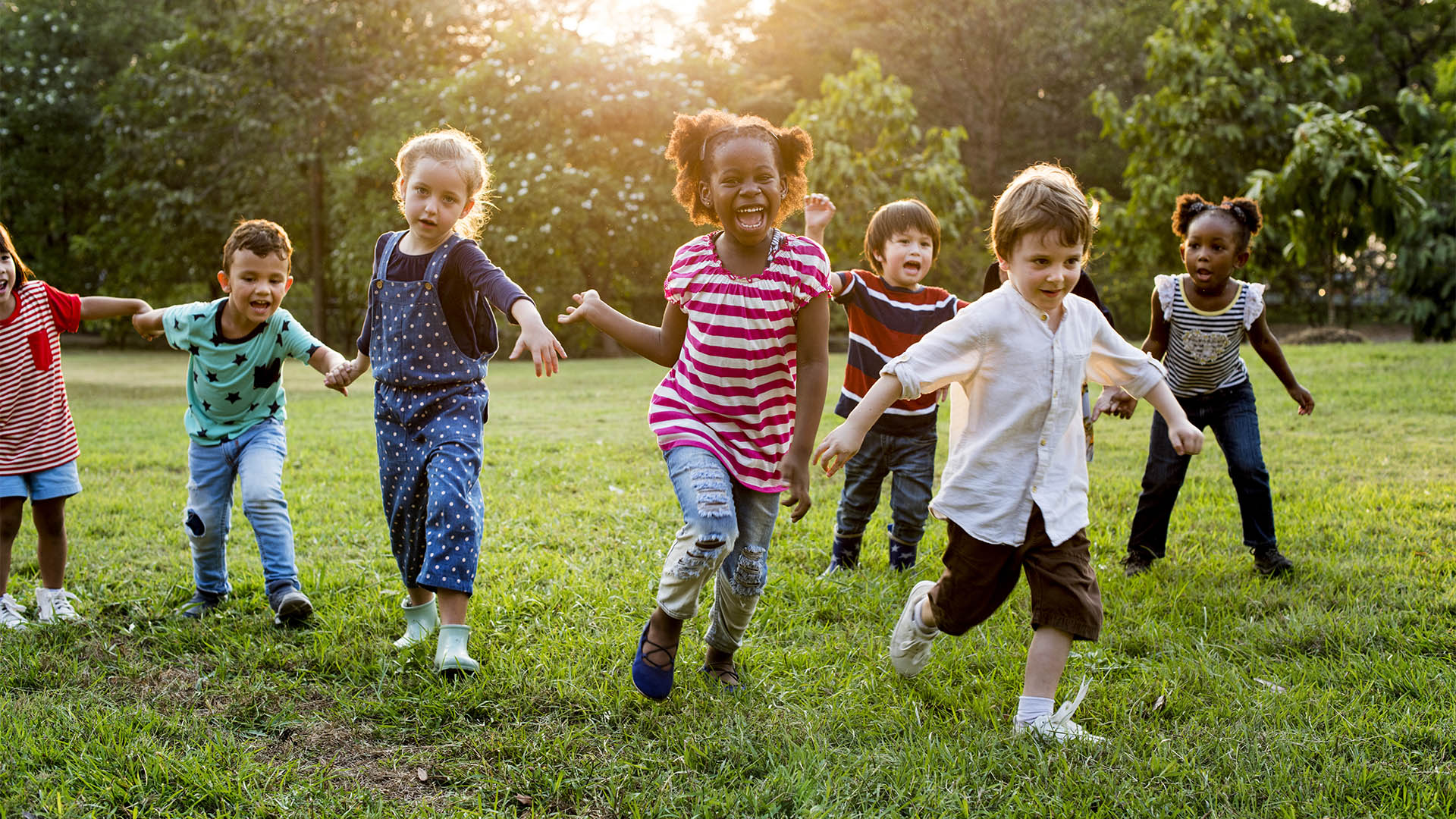 Group of Diverse Kids Playing at the Field Together
