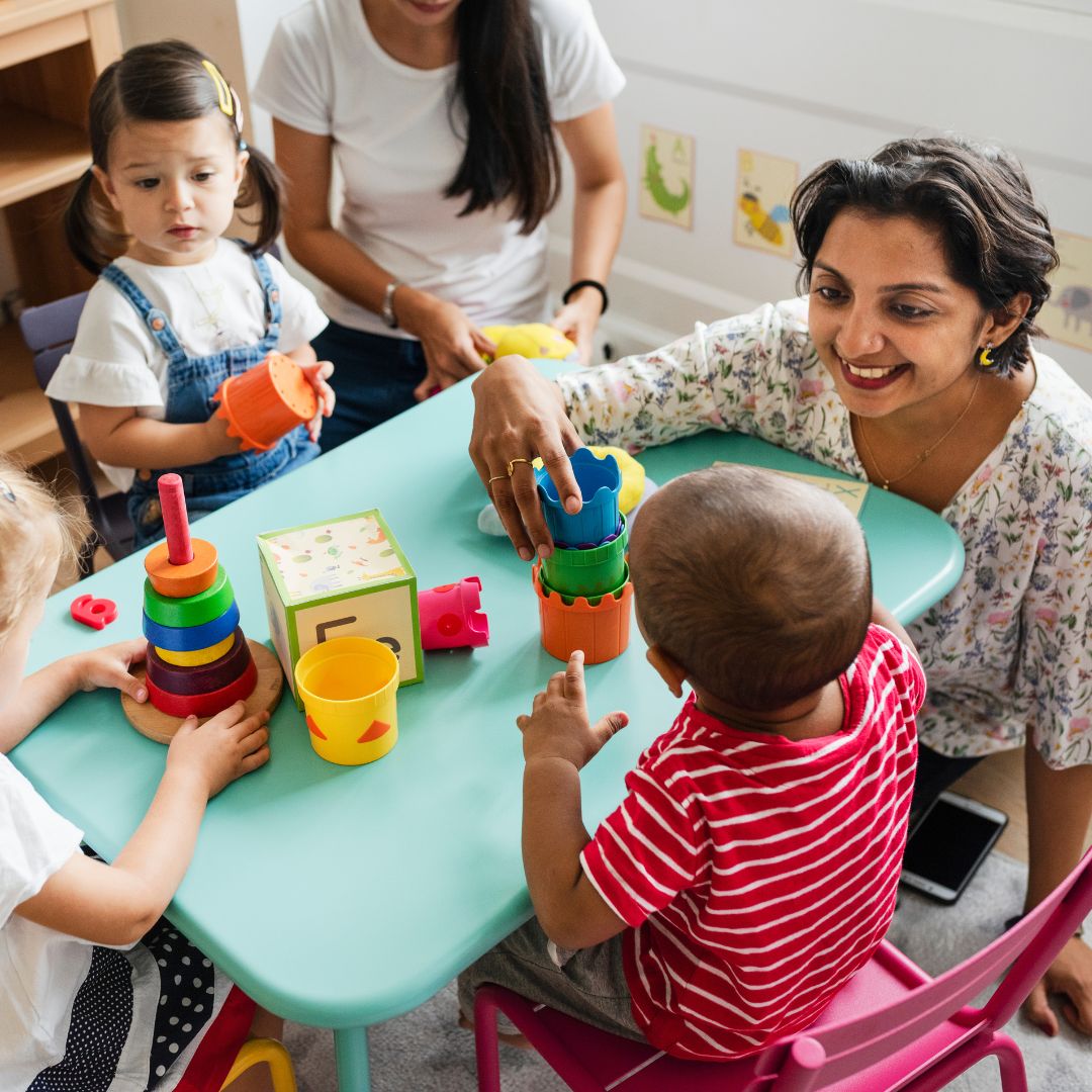 Daycare helper playing with kids