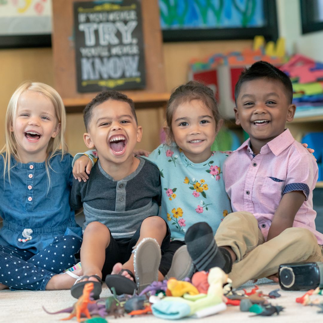 A group of preschoolers smiling for camera