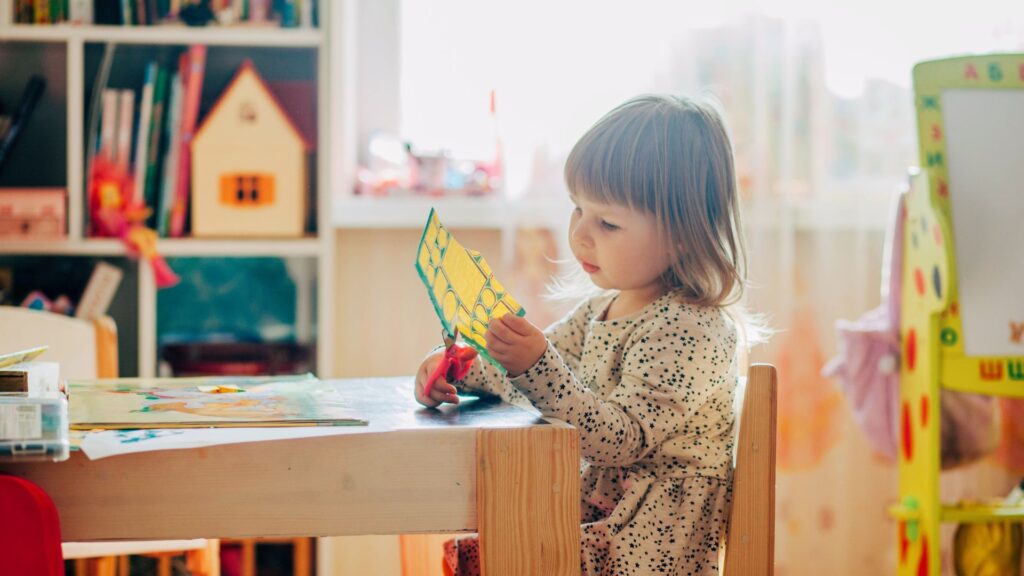 Preschool student cutting a craft