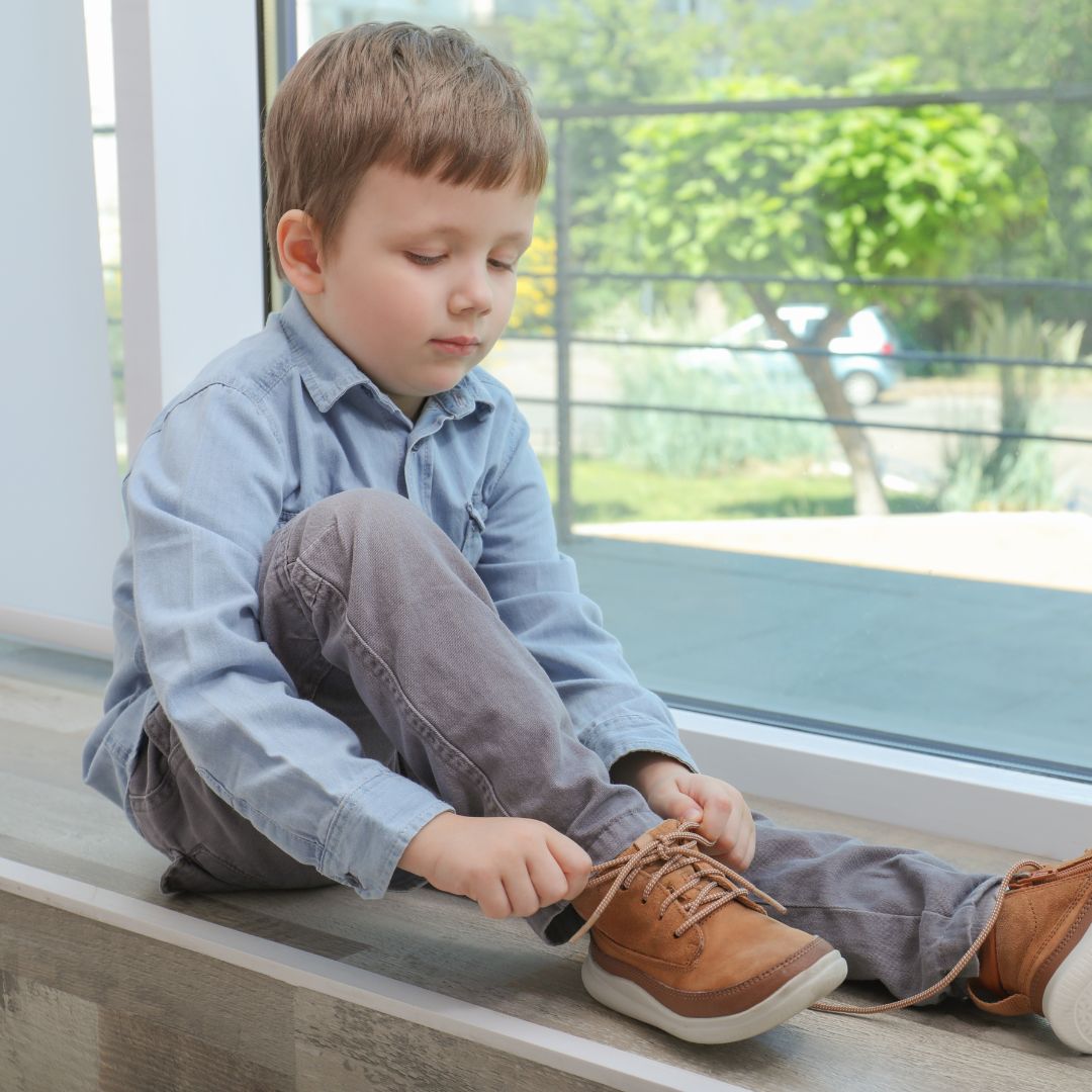 boy tying shoes