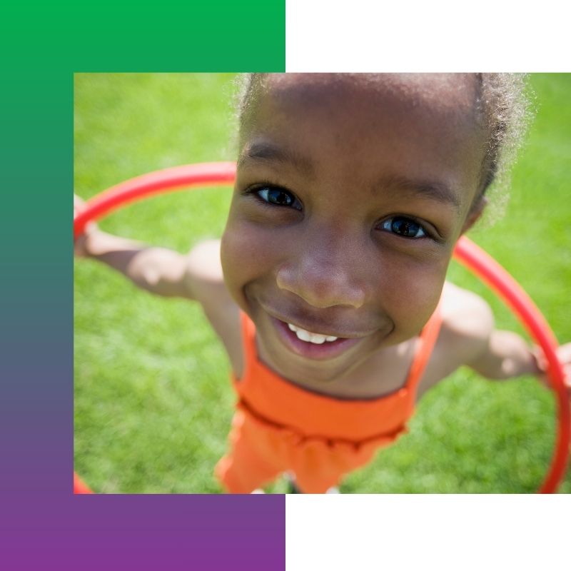 A child playing with a hoola hoop