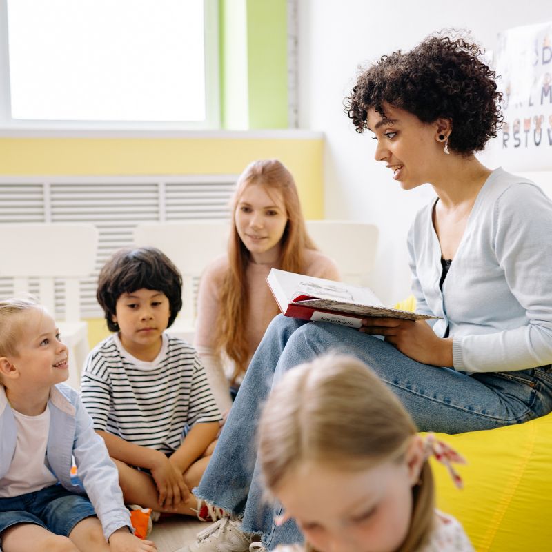 childcare teacher reading to children
