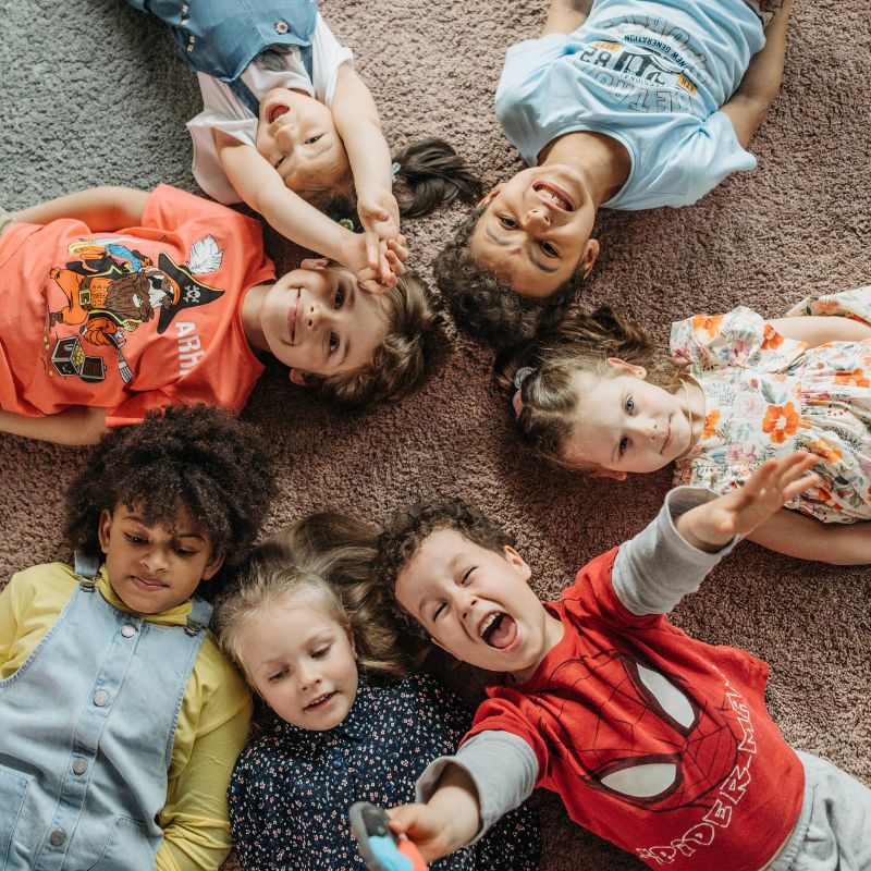 Children laying on carpet