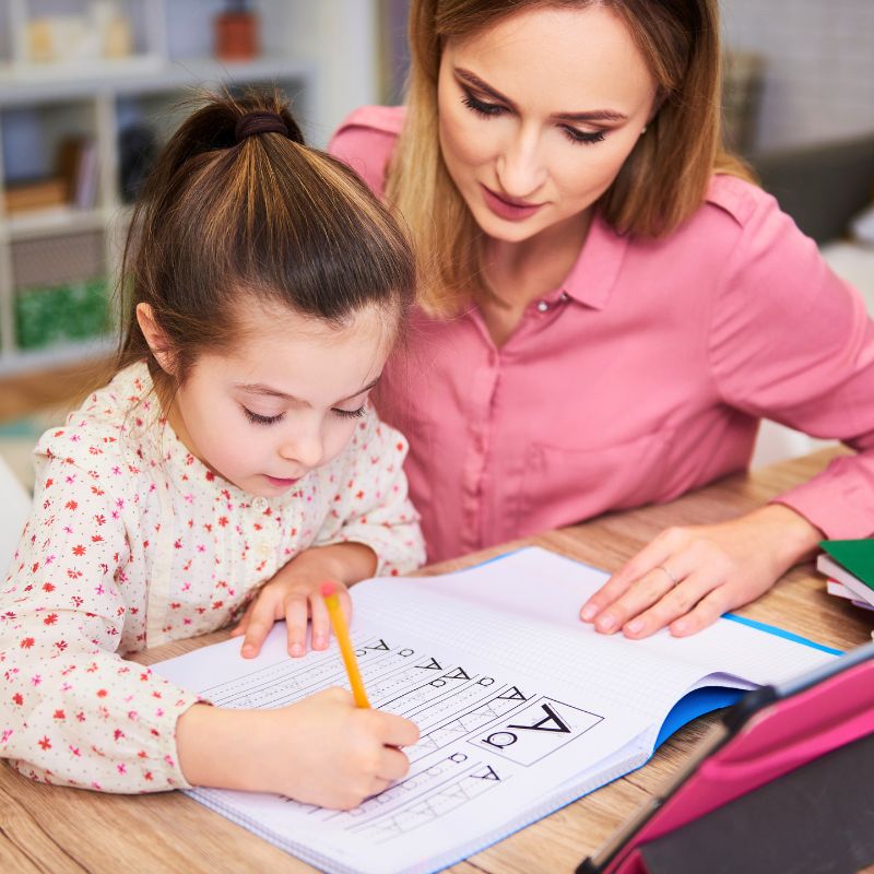 after school educator helping girl with homework