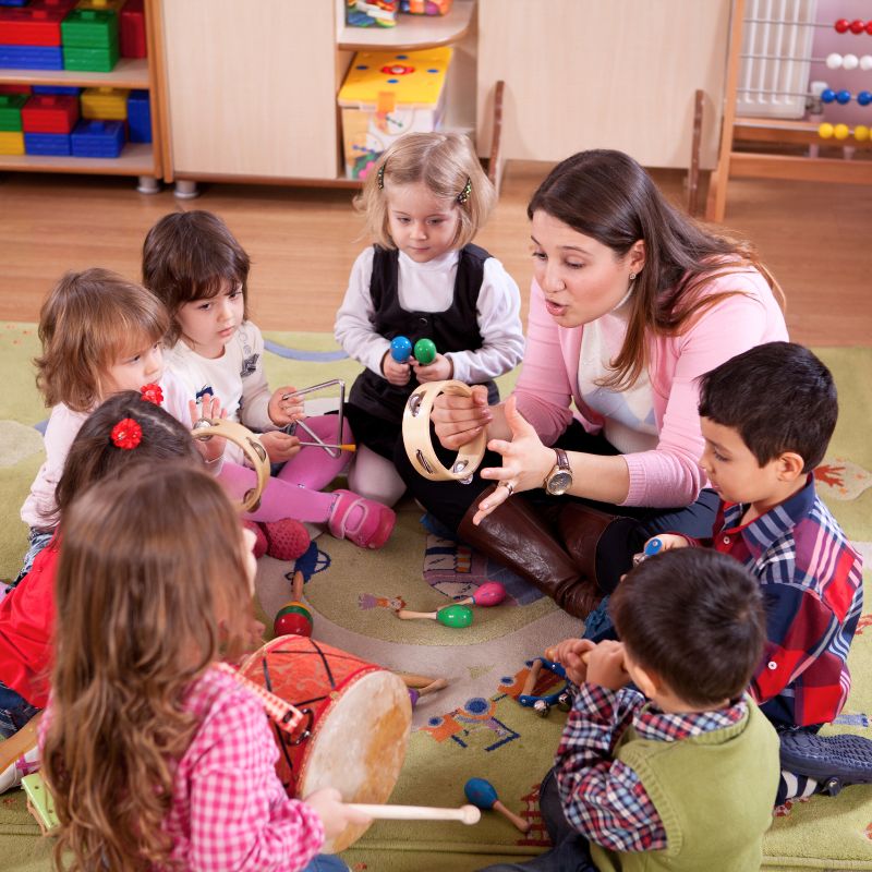 preschool teacher playing music with children